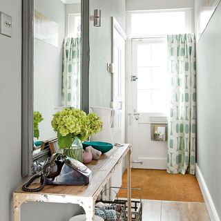 hallway with console table and white wall
