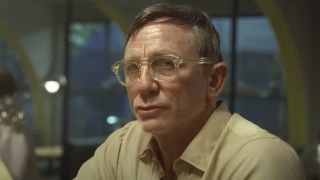 Daniel Craig wearing glasses and a beige shirt in Queer