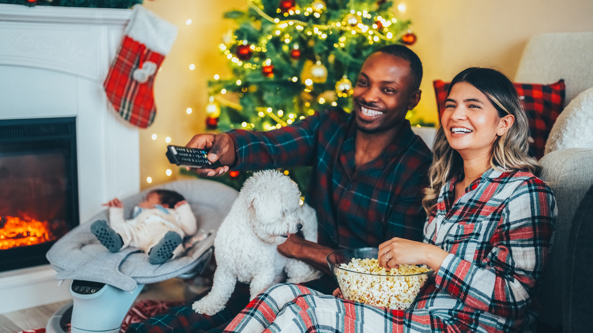 family watching movie at christmas with dog and popcorn