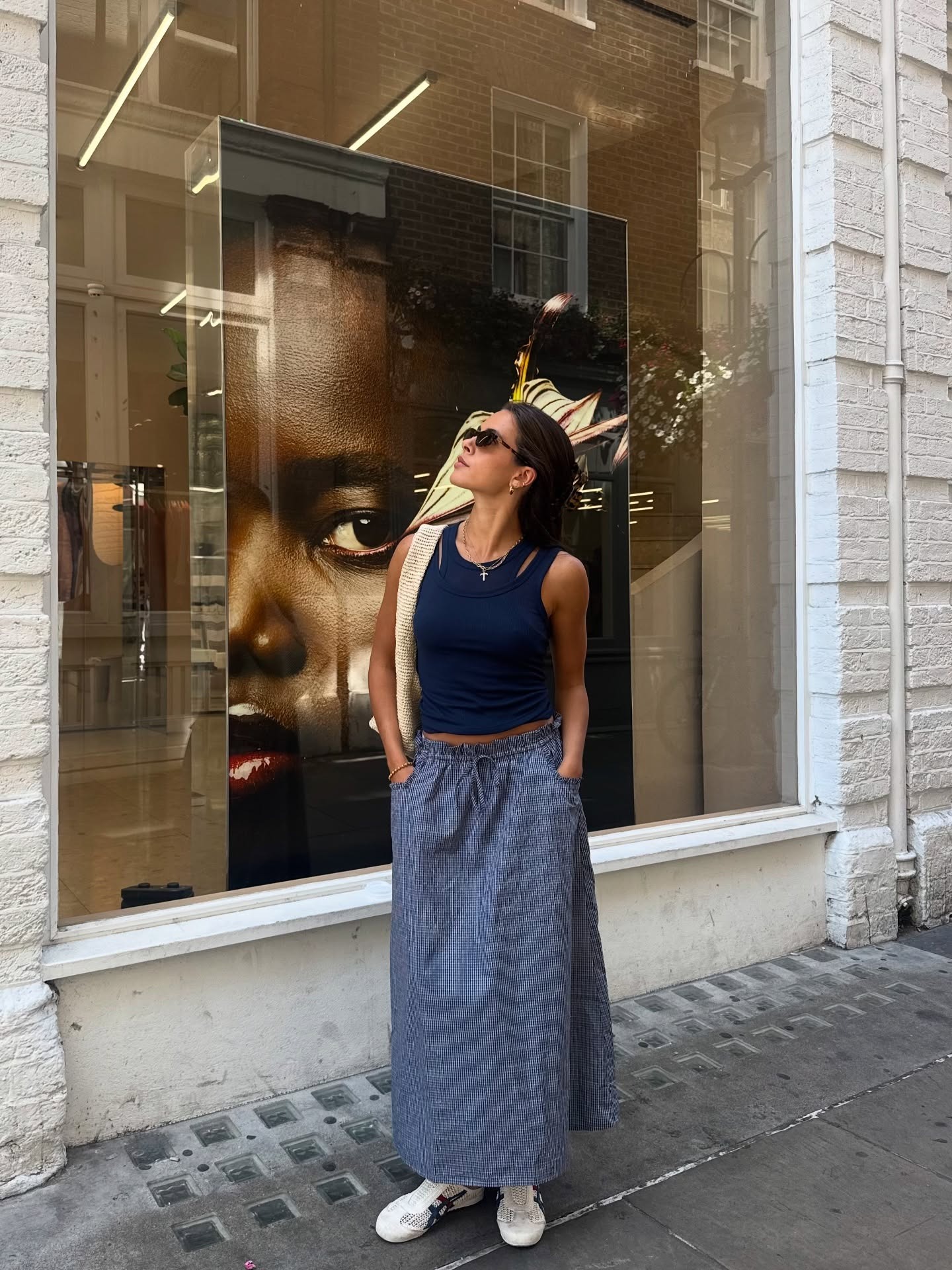 Fashion person Tia Dewitt wears a blue maxi skirt, racer tank layered with a matching scoop neck and Onitsuka Tiger trainers