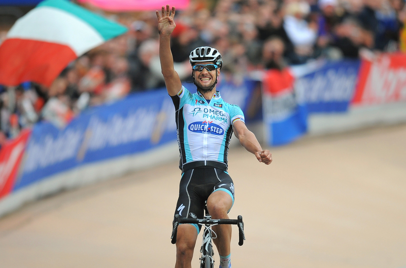 Tom Boonen raises four fingers in the arm as he wins the 2012 edition