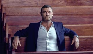 Ray Donovan sits in a pew in church