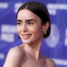 Lily Collins on a red carpet 