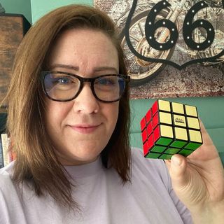 Me holding my finished Rubik's Cube
