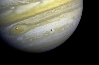 Voyager 1 took photos of Jupiter and two of its satellites (Io, left, and Europa). The new study says that moons orbiting a gas giant planet greater than 8 Jupiter masses could help astronomers detect a rogue planet.