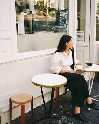 Sophisticated Fashion Trends: @michellelin.lin wears a white shirt, black trousers and loafers