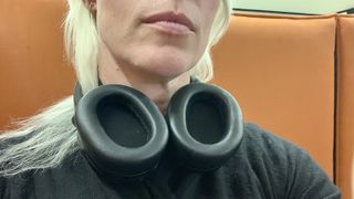 Edifier Stax worn by Becky Scarrott, around the neck to show that the earcups rotate out, rather than in