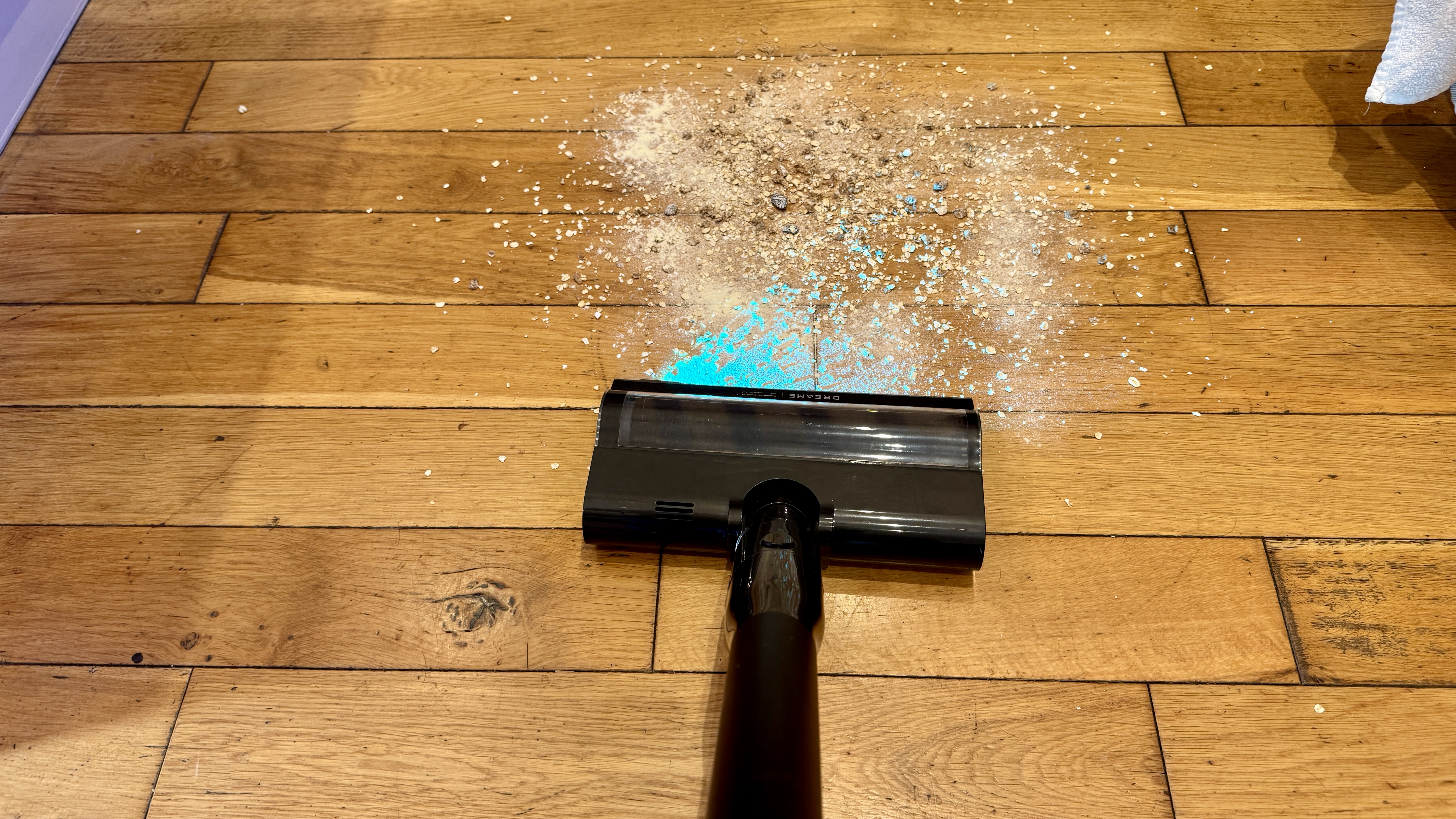Dreame V20 Pro vacuum cleaning mess from a hard floor
