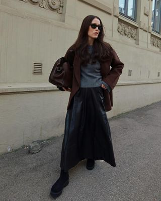 @annabelrosendahl wearing lug-sole suede boots with a leather skirt