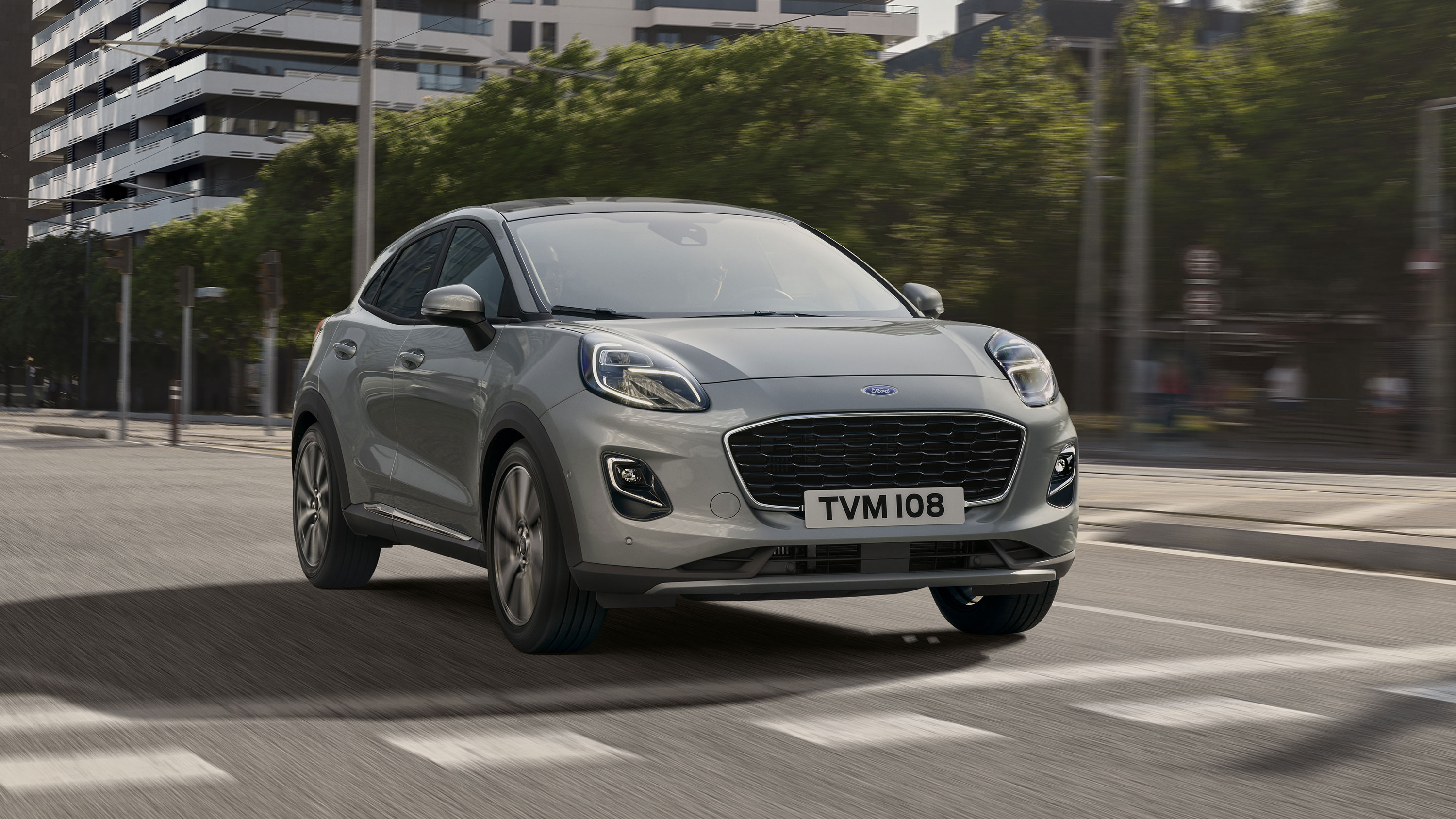 A grey Ford Puma driving in a city