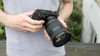 Sony ZV-E1 digital camera being held in two hands by reviewer