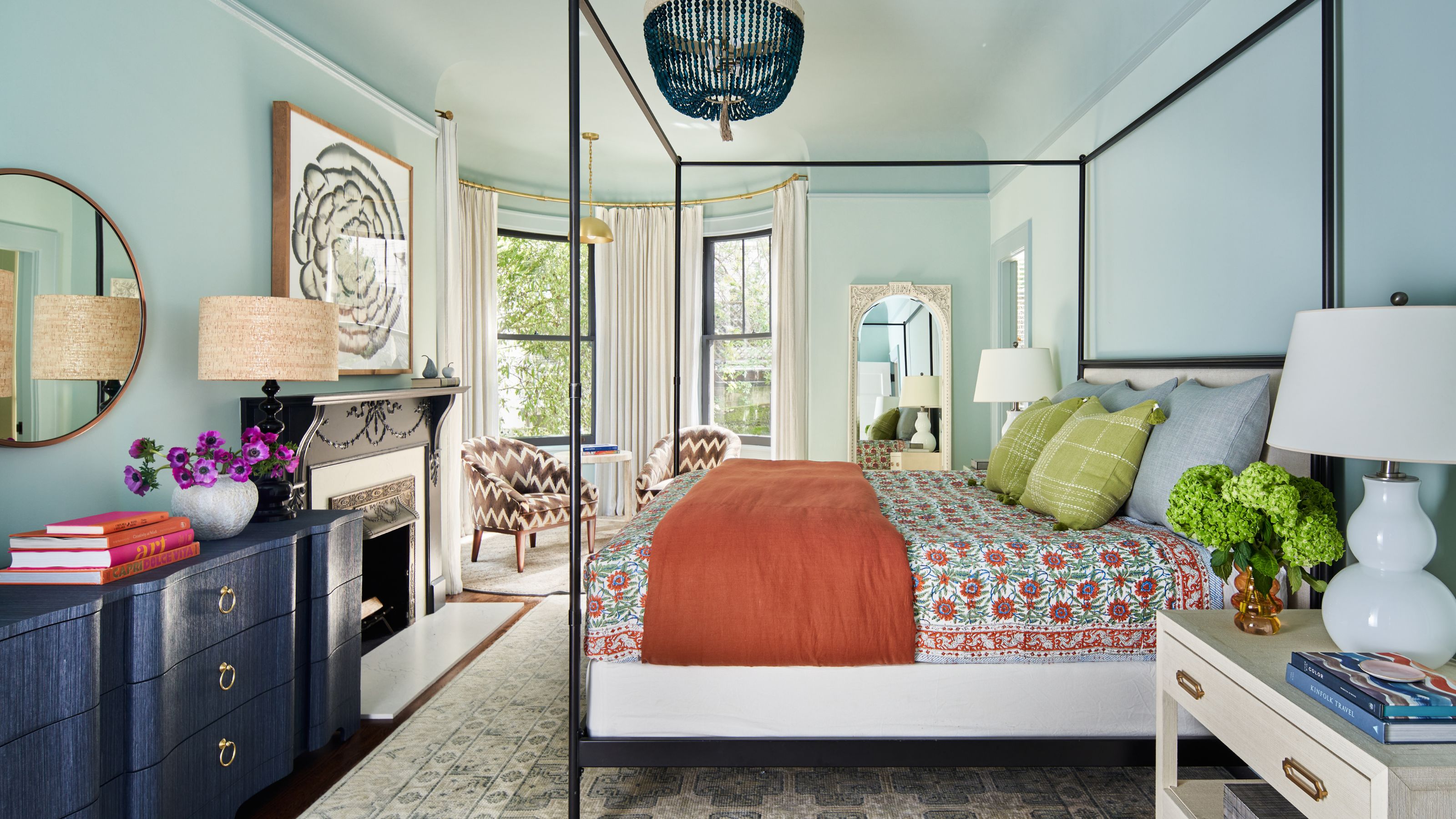 pale blue color drenched primary suite in a historic san francisco home with a four posted bd, fireplace, and accents of blue and green