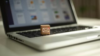 A tiny email icon on a box sitting on a laptop's keyboard