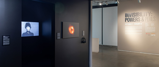 A gallery. On one wall, an image of the Milky Way's black hole hangs.