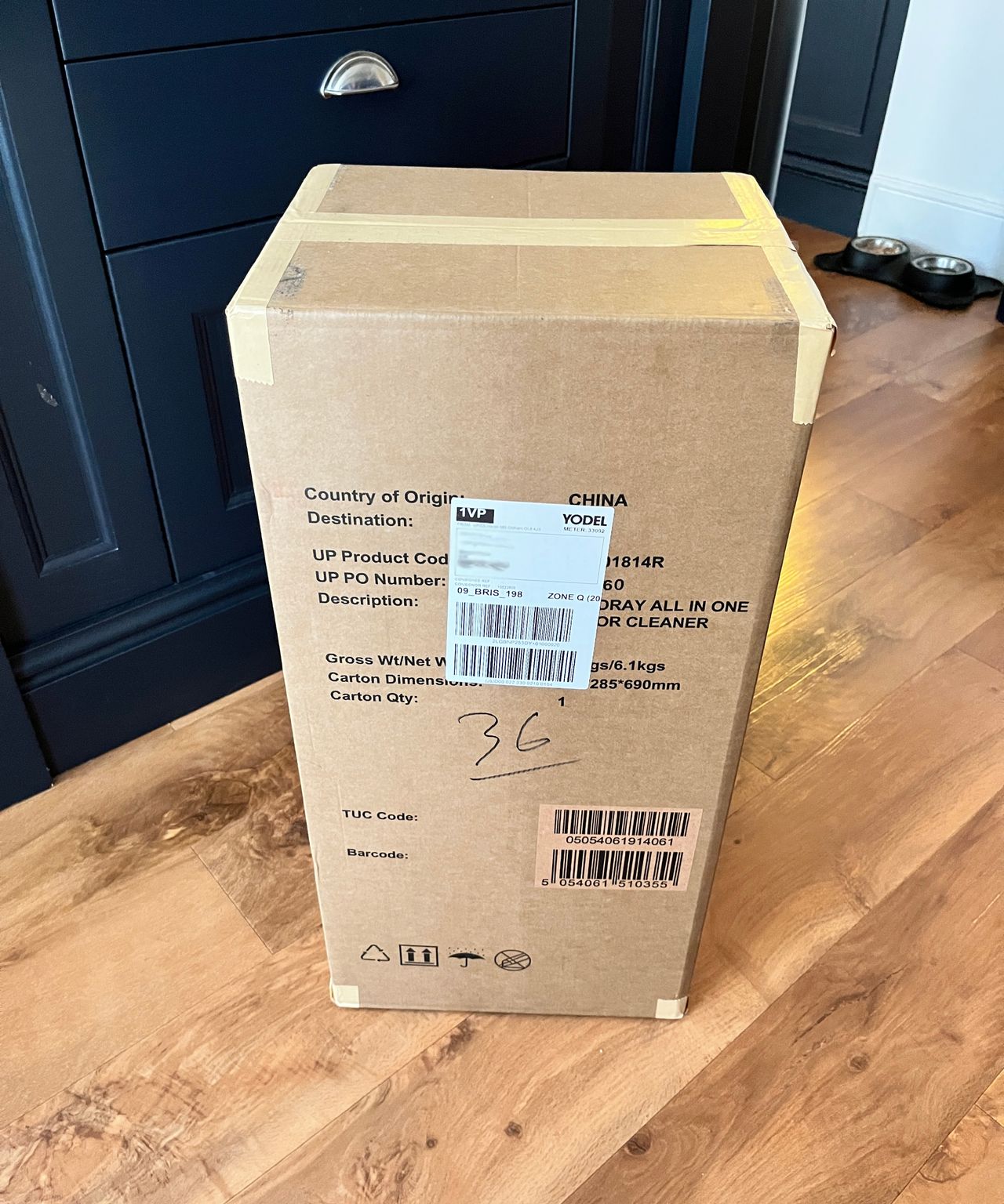 large cardboard box stood on kitchen floor
