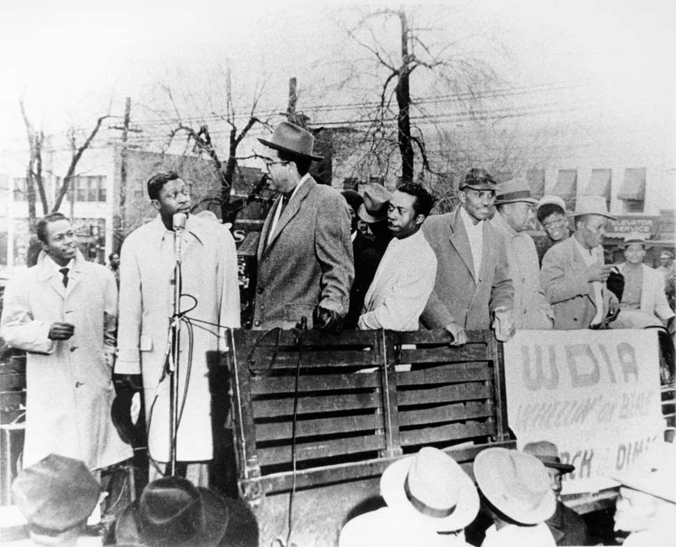 Blues musician B.B. King stands on the back of a truck with other African-American men to raise money for radio station WDIA's Wheelin' On Beale March of Dimes charity for pregnancy and baby health in circa 1955 in Memphis, Tennessee