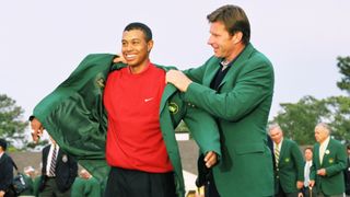 Tiger Woods is presented with his first Green Jacket by Nick Faldo after becoming the youngest Masters champion in 1997