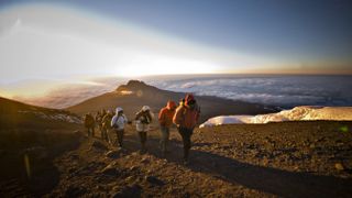 A team of hikers approach the summit of Mt. Kilimanjaro
