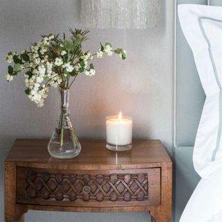 flower pot and candle on bedside table to make your mind calm