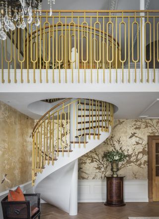 9 Millbank Heritage Collection by Goddard Littlefair - a gold wallpapered room with a spiral staircase.