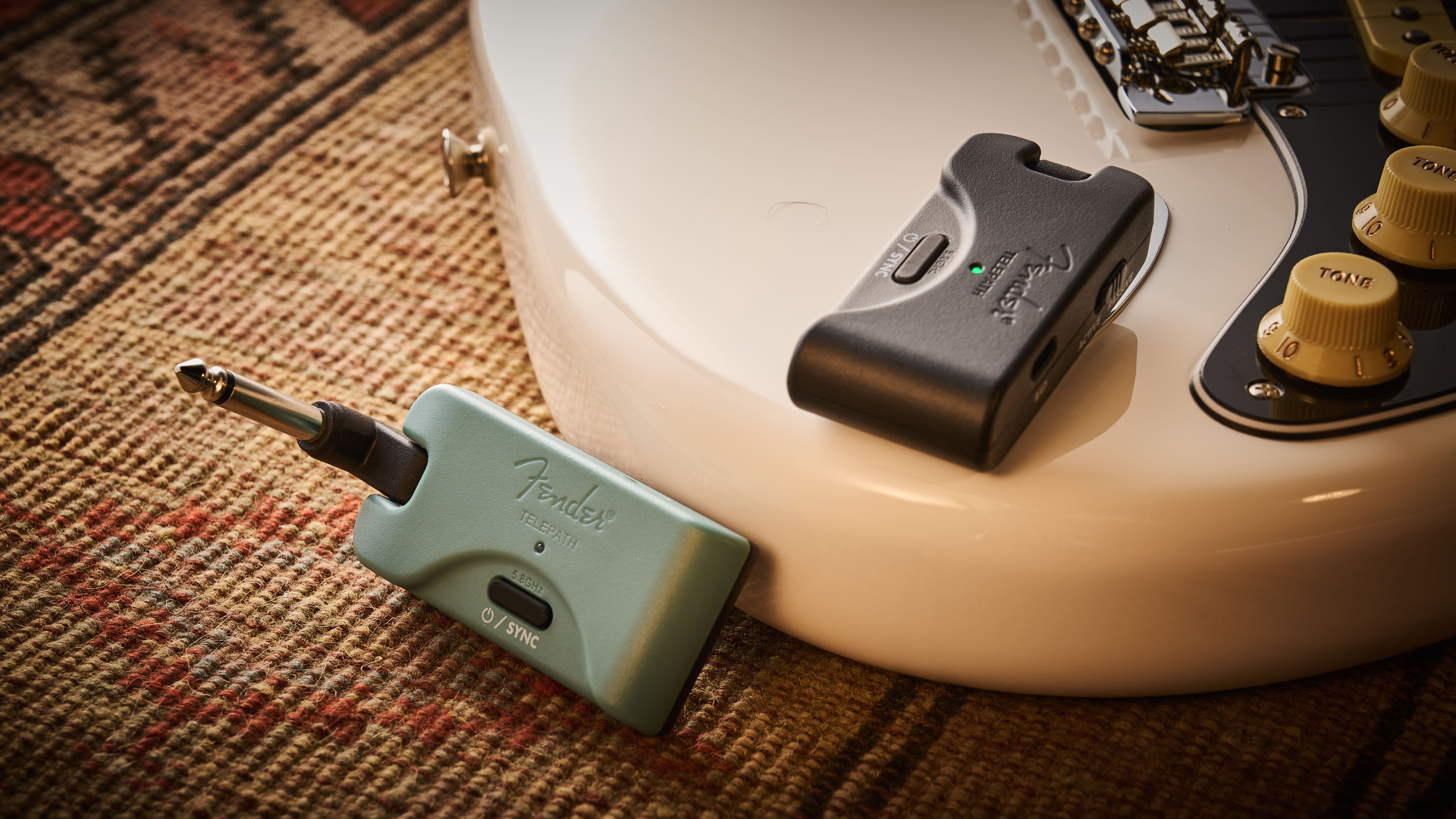 A Fender Telepath Wireless guitar system on top of a Stratocaster guitar