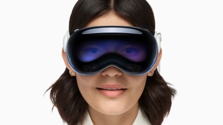 Apple Vision Pro being worn by woman on white background