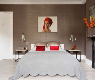Art Deco bedroom with luxurious wall sconces and red accents
