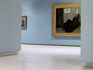 Large gilt-framed portrait of an elderly lady seated in a full-skirted black dress with white bonnet. The portrait hangs on a bluish-grey wall in an art exhibition.