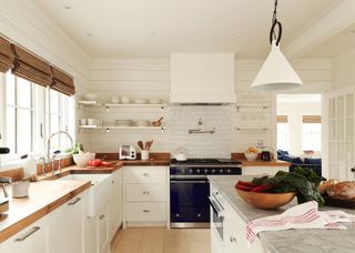 A white kitchen with butcher block countertop