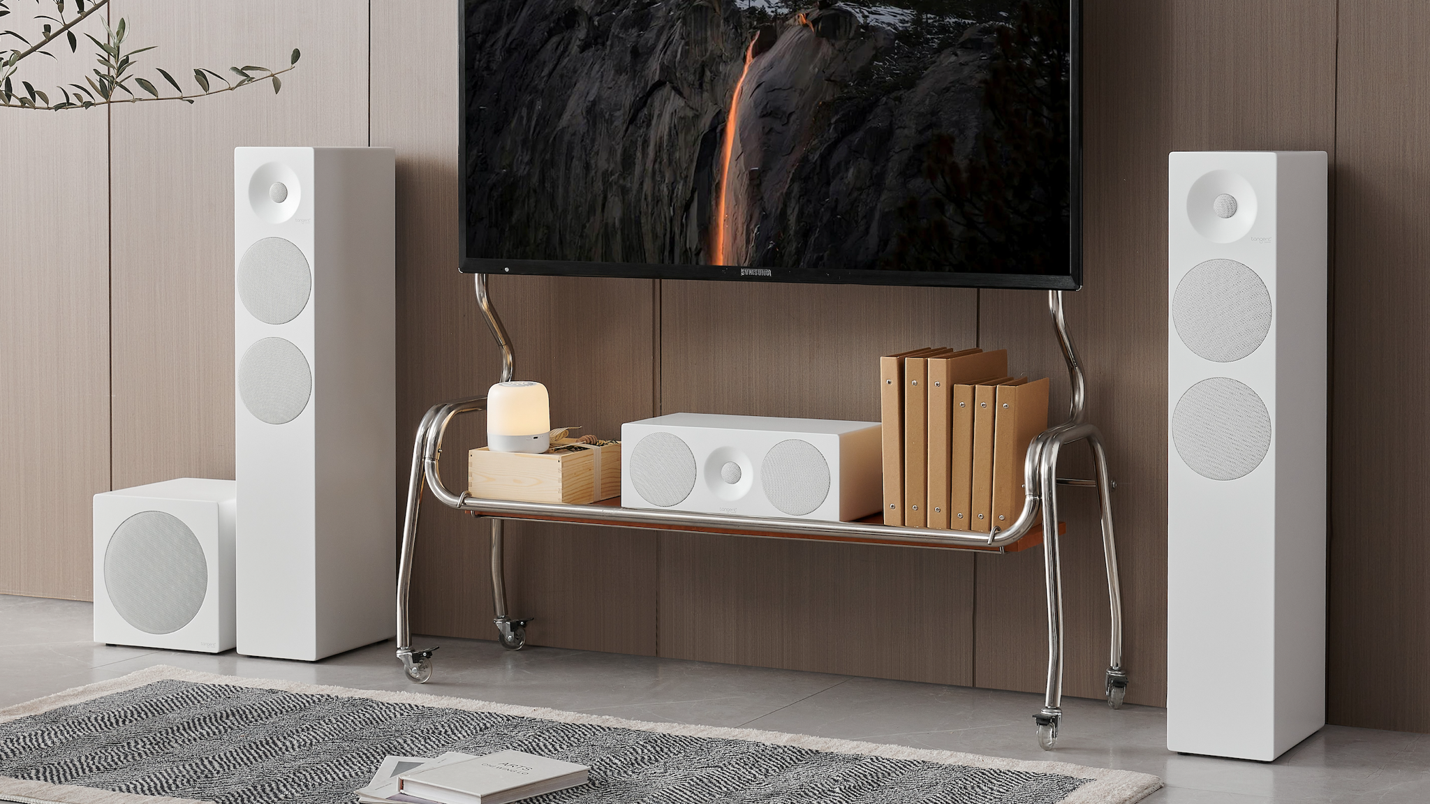 A home cinema setup featuring Tangent Spectrum II speakers in white in a neutrally decorated room 