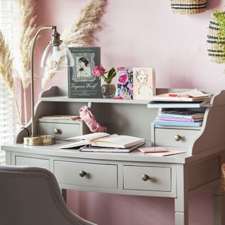 Grey desk decorated with personal items