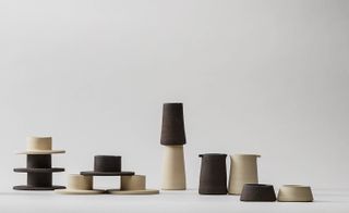 Crockery includes bowls, jugs and egg-cups in chalky hues of milky coffee and darker chocolate.
