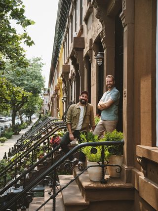 The Brownstone Boys standing on the front steps of a Brownstone Building