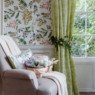 living room with grey sofa and green printed curtain