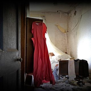 the red dress hanging on wardrobe