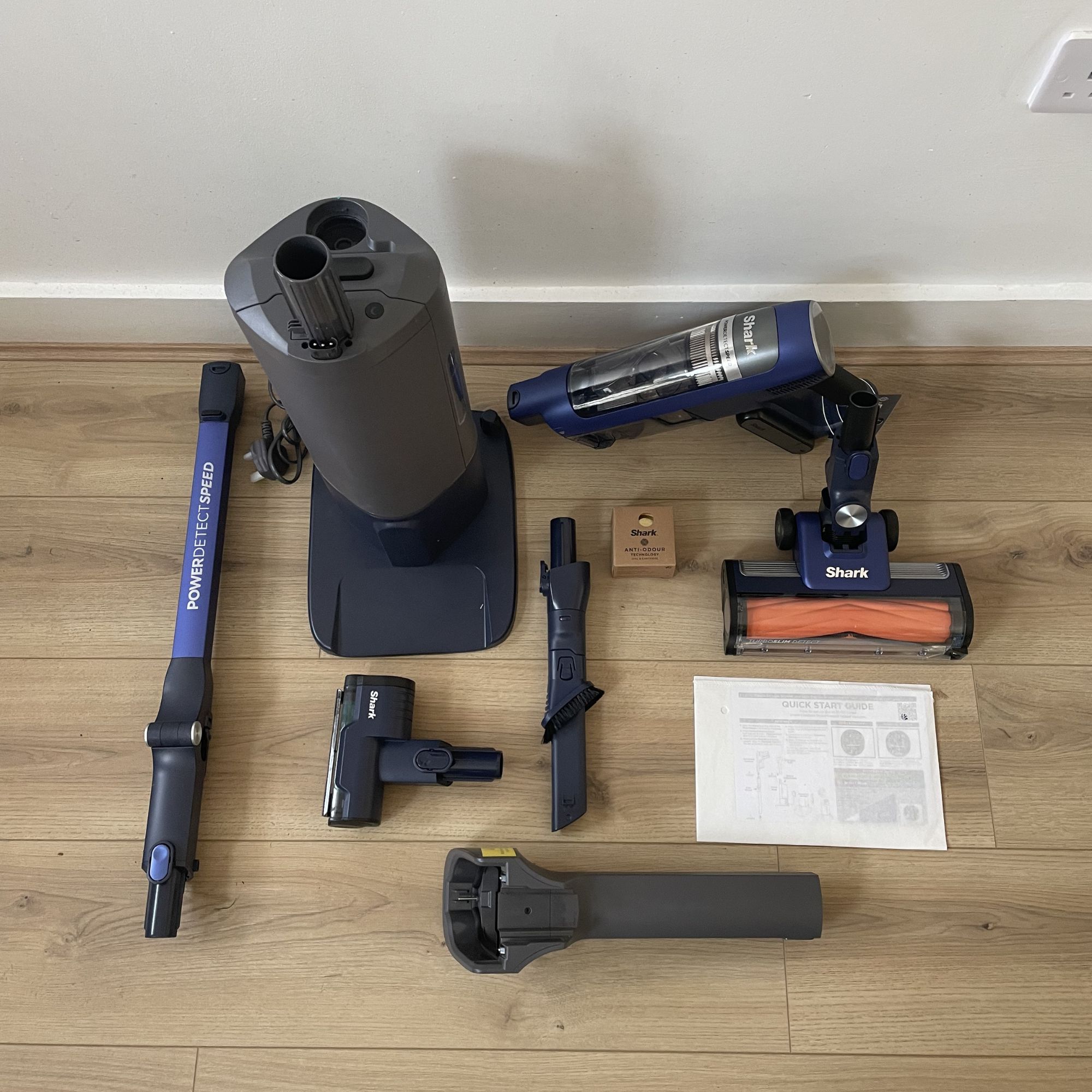 Components of the Shark PowerDetect Speed laid out on wood-effect flooring
