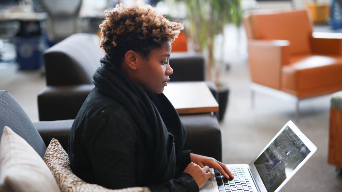 Woman using Facebook on laptop