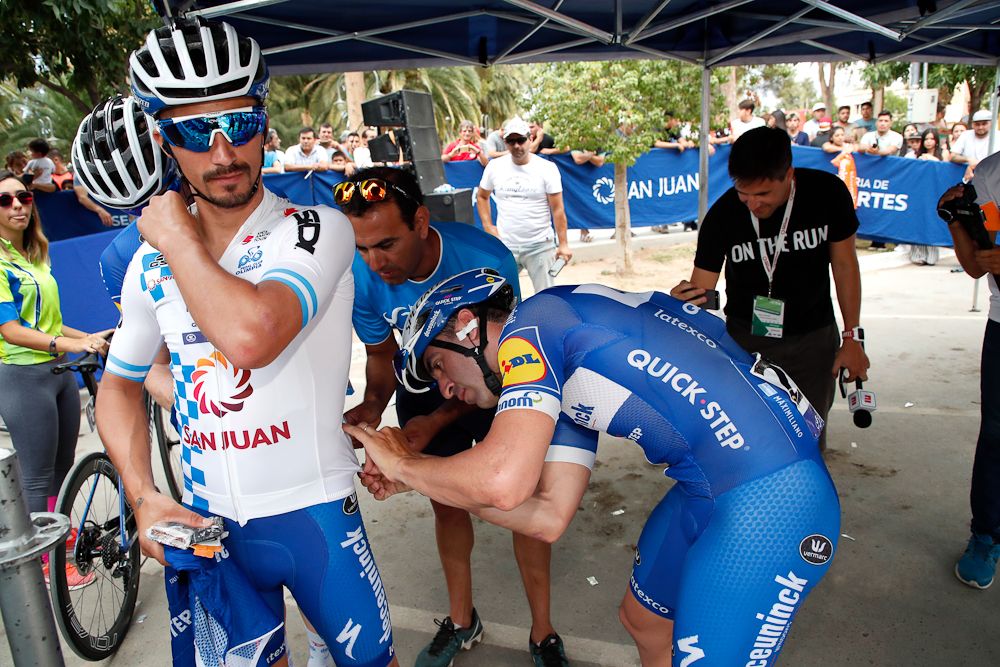 Race leader Julian Alaphilippe (Deceuninck-QuickStep) gets some help pinning on his numbers before the start of stage 4 in San Juan