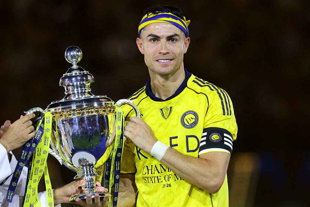 Cristiano Ronaldo poses with the trophy after winning the Saudi Pro League title.