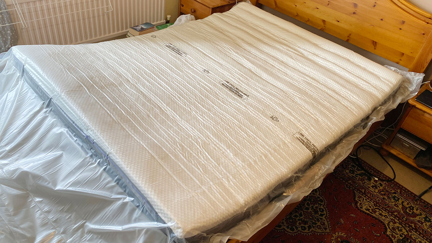 The Nectar Premier Hybrid mattress in its plastic wrapping