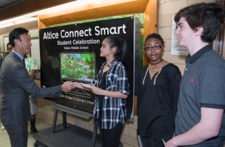 Altice USA CEO Dexter Goei with students before an "Altice Connects" community event. 