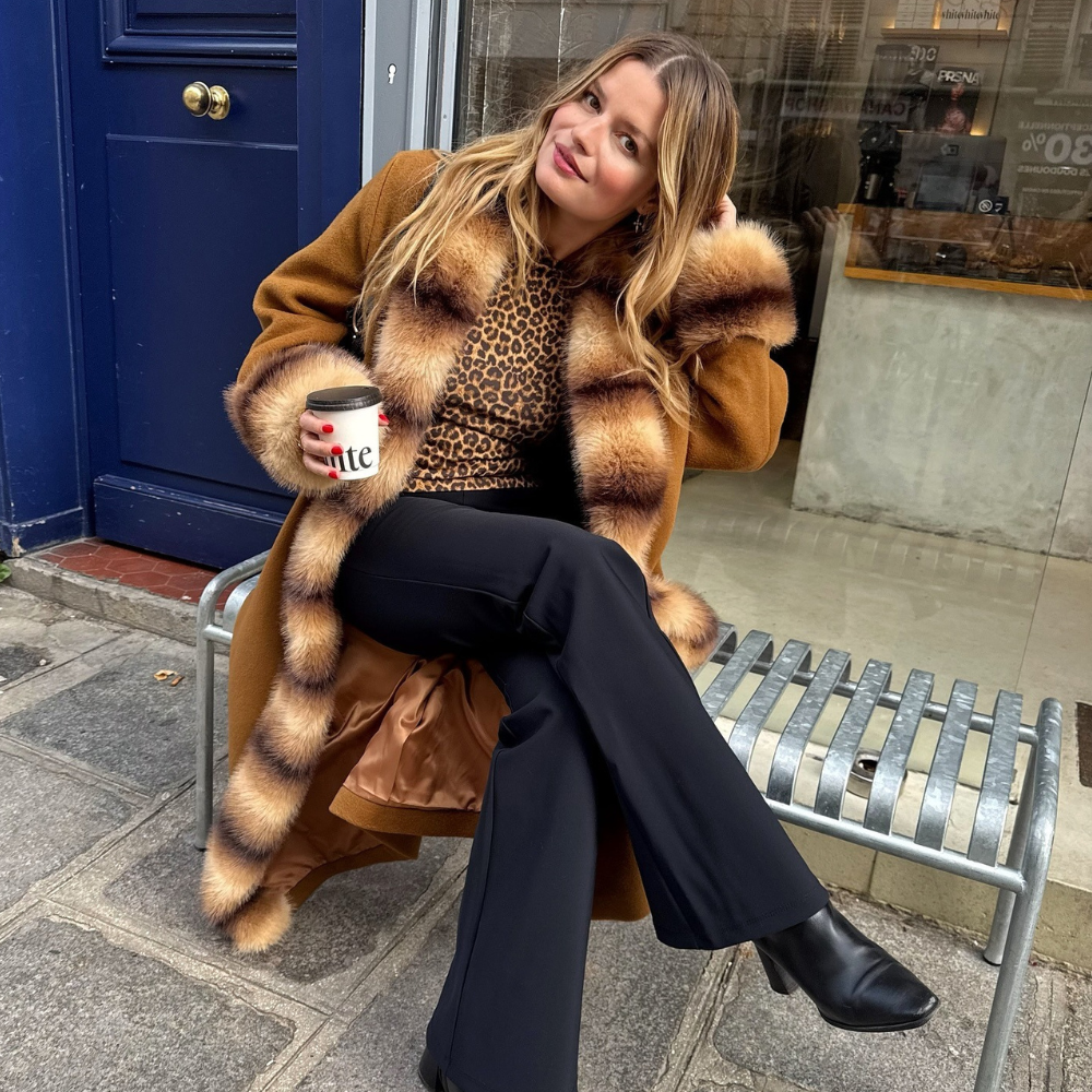 Fashion person Sabina Socol wears a faux fur jacket outfit.
