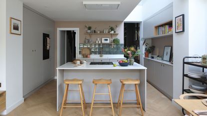 room with white shelves wooden door and tiled flooring