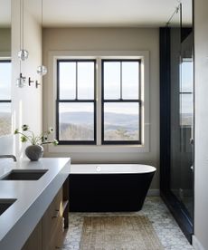 gray bathroom with black bath