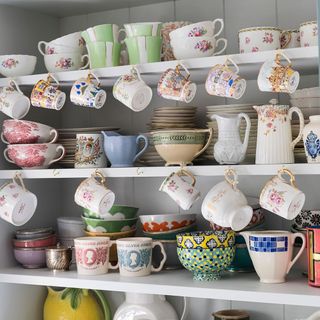 open crockery shelve with cup and bowl