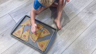 child with cardboard pizza