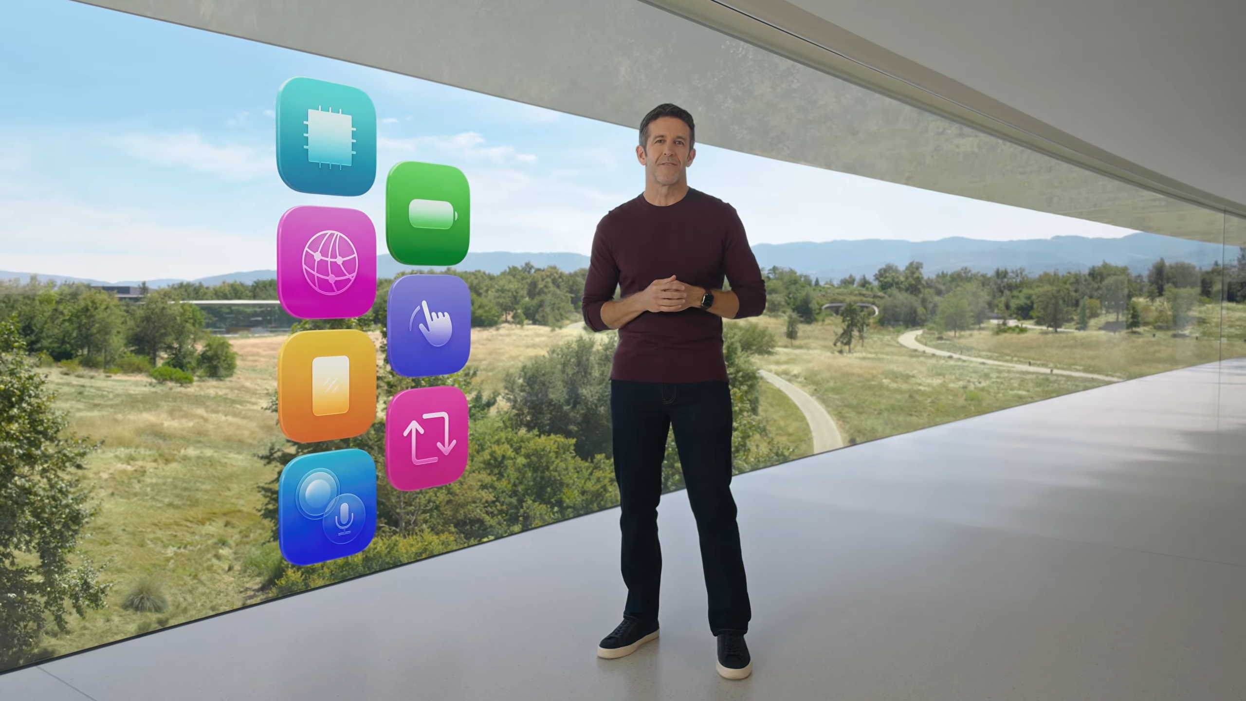 John Ternus next to Apple software and hardware stack