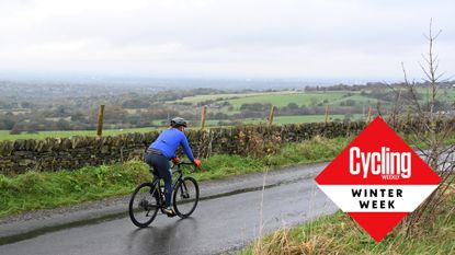 rider in winter gear cycling on beautiful road