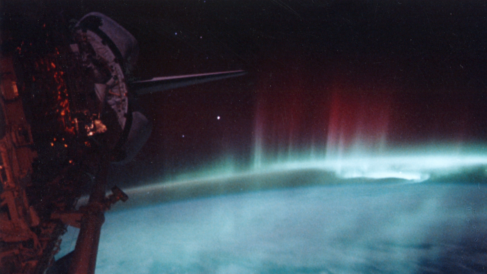 A red and green aurora as seen from outer space