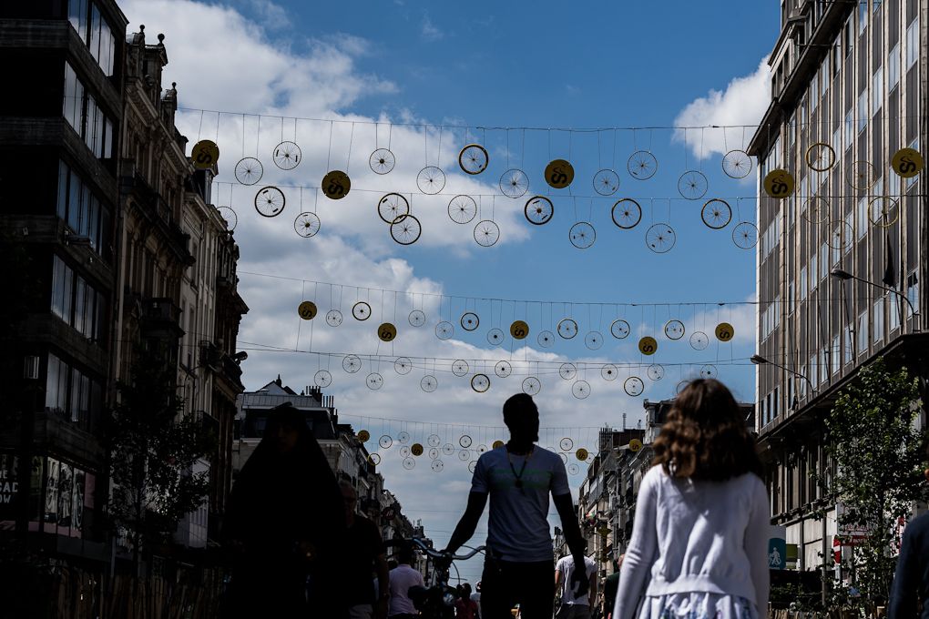 Tinsels with bicycle wheels hanging in a street in Brussels centre